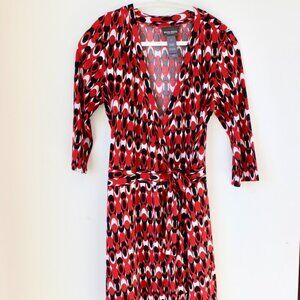 Bisou Bisou wrap dress with a red, black, and white geometric pattern